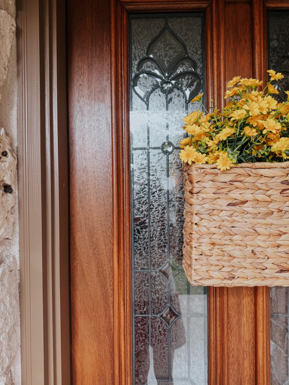 close up of front door basket with faux yellow flowers