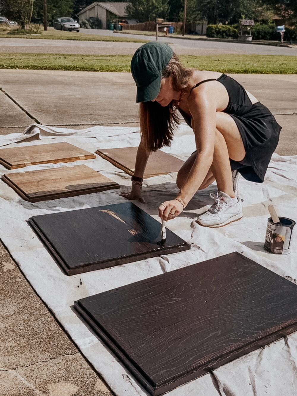 woman using gel stain to stain a cabinet door