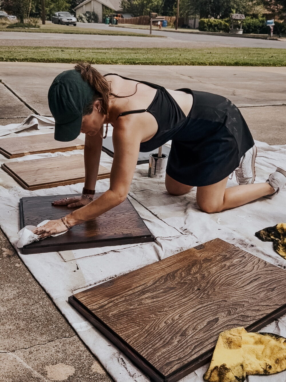 woman removing excess gel stain from cabinet doors
