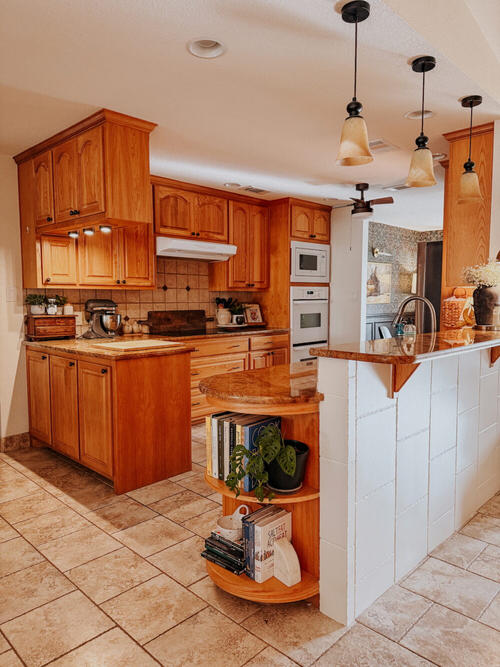 dated kitchen with honey oak cabinets and a brown countertop