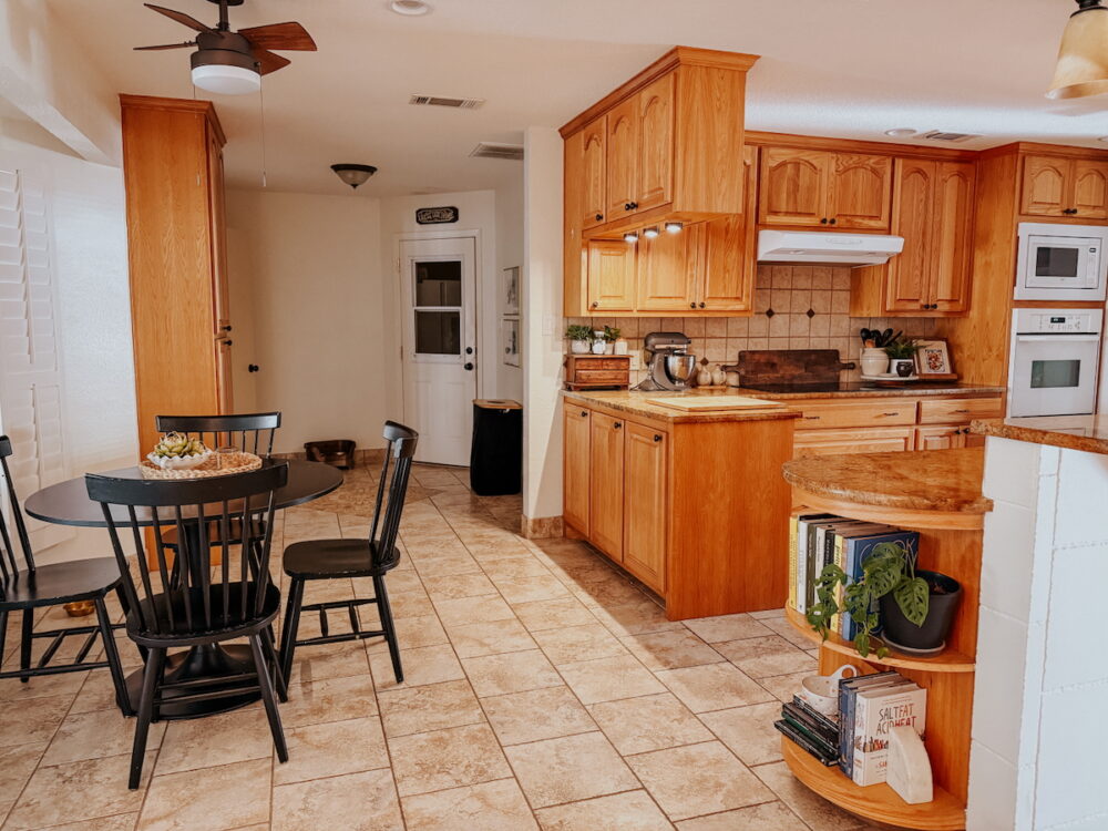 horizontal image of a 90's style kitchen with honey oak cabinetry