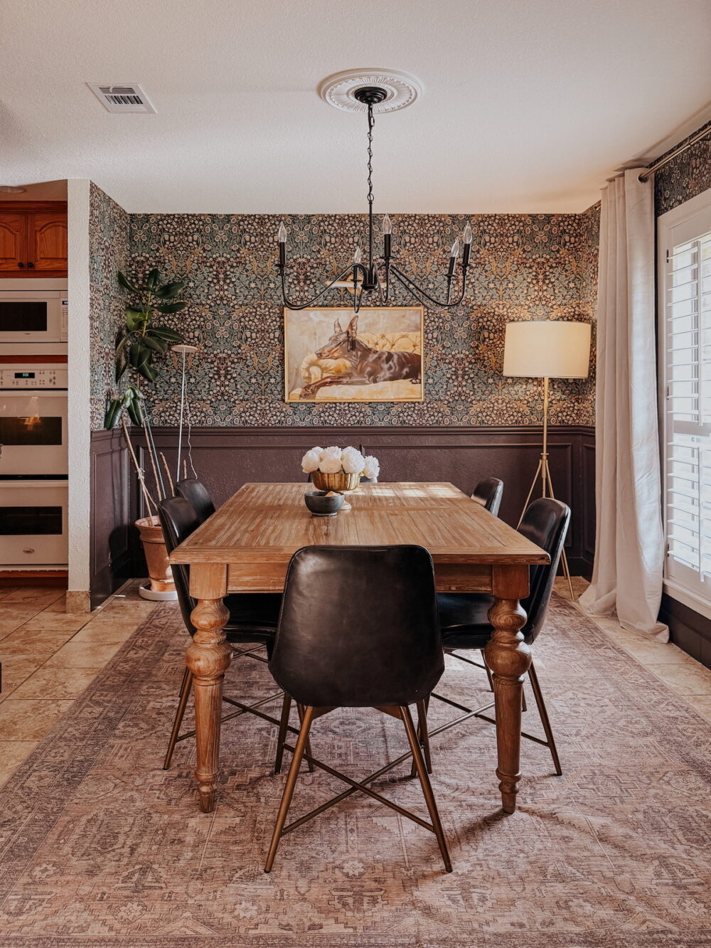 dining room with brown trim on bottom half of the walls and brown floral wallpaper on the top half