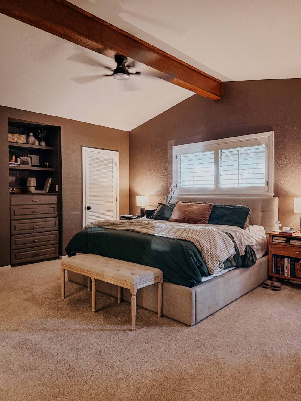 bedroom with brown walls, a built-in dresser and a bed with green bedding