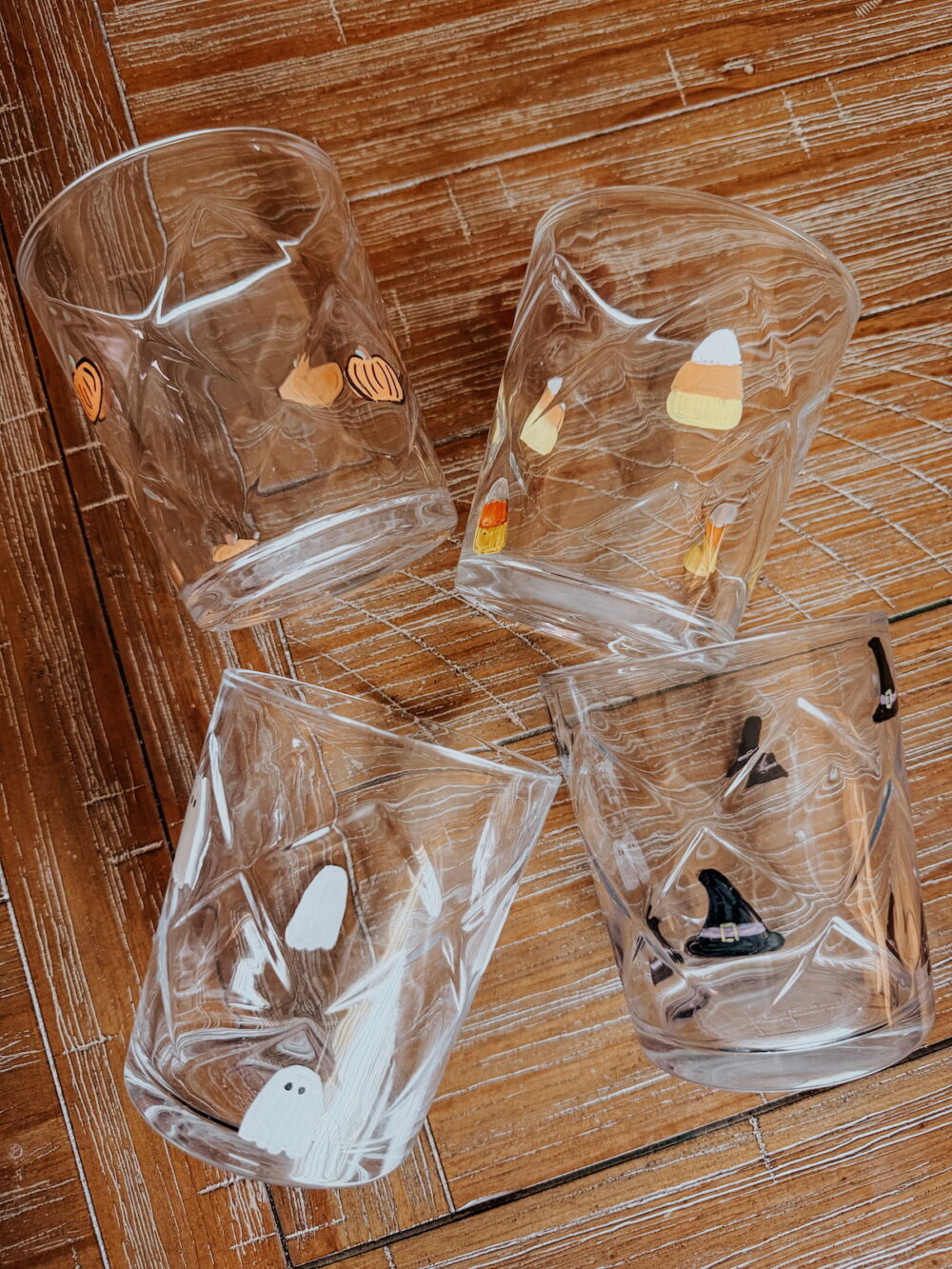 4 glasses on a table with painted icons for Halloween