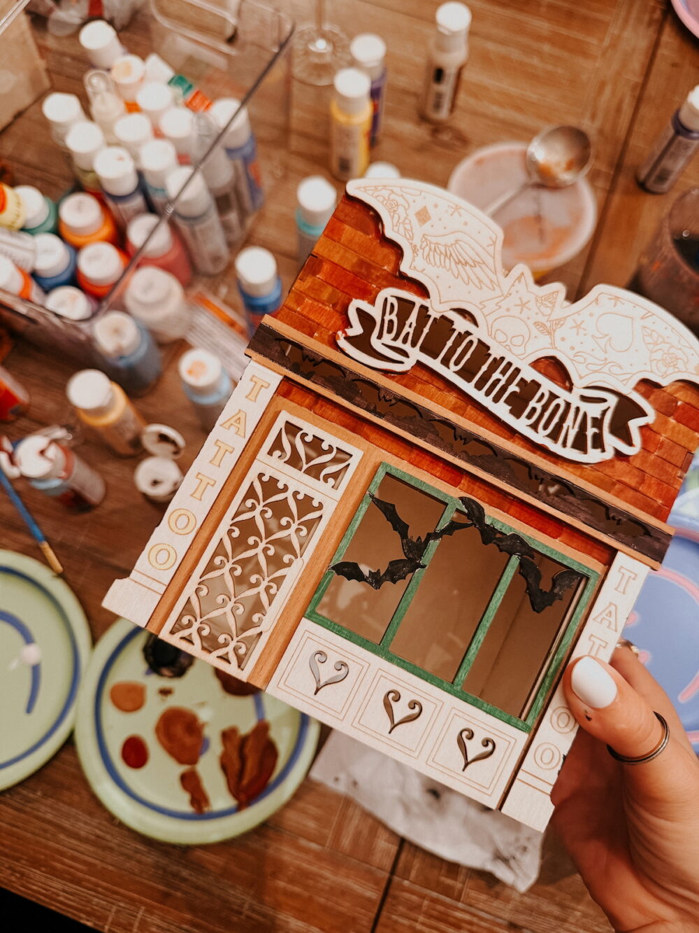 a painted wooden craft house for halloween