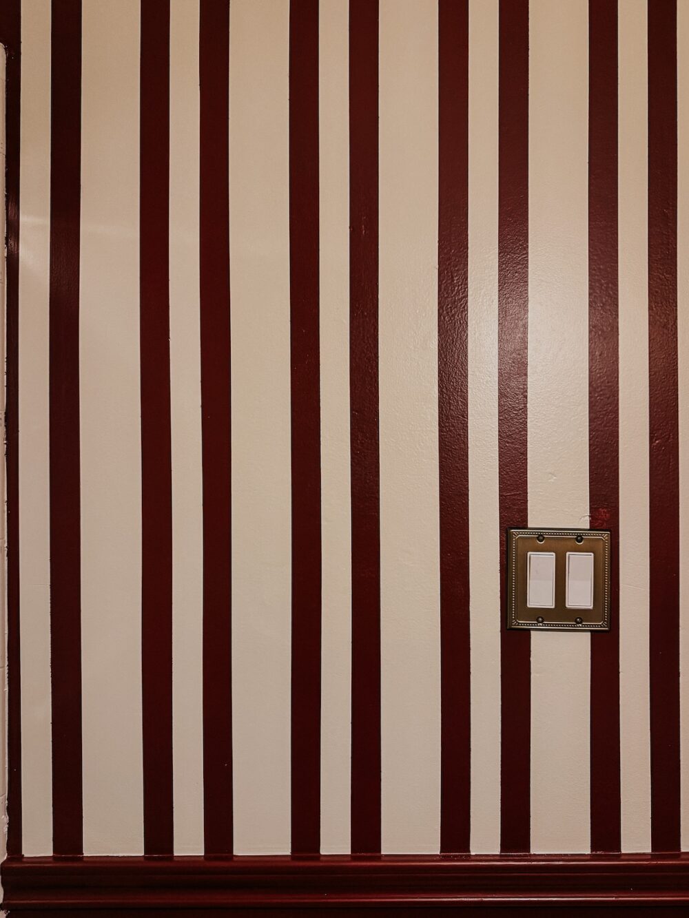 close up of red and white stripes on a wall