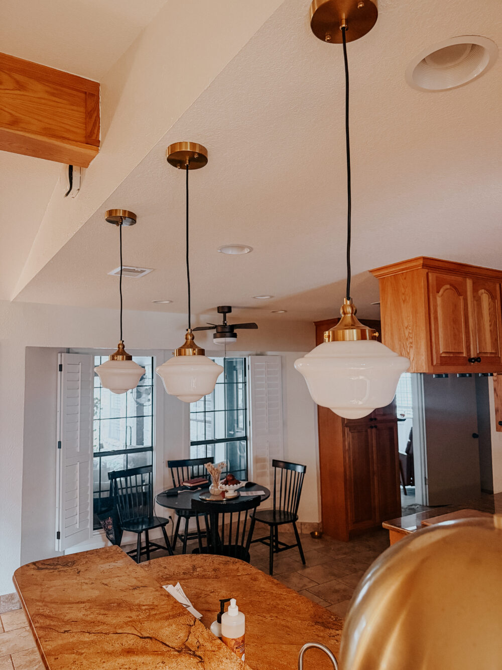 close up of schoolhouse pendant lights in a kitchen