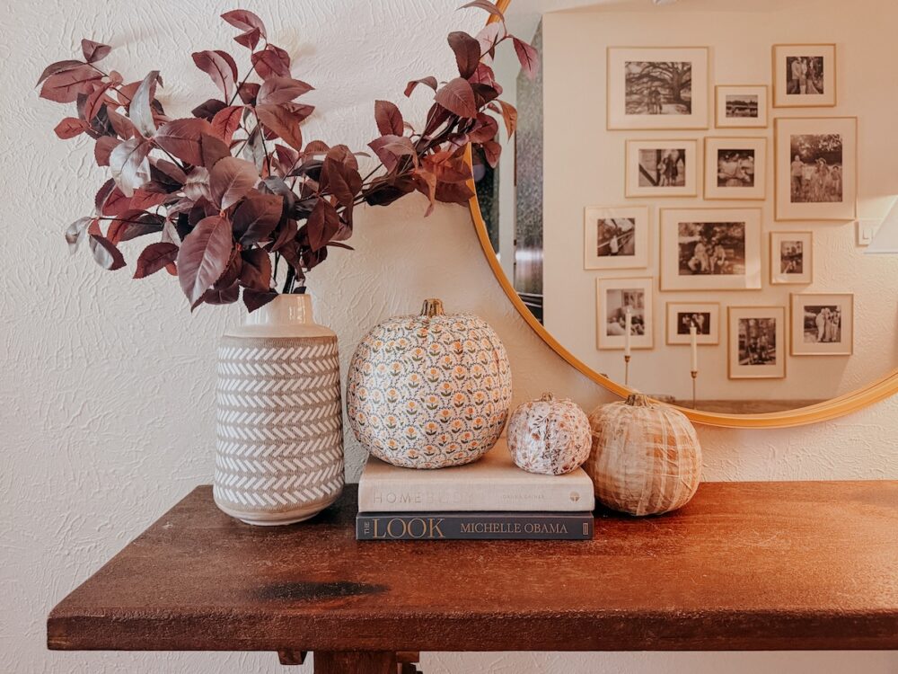 decoupaged pumpkins on an entry table