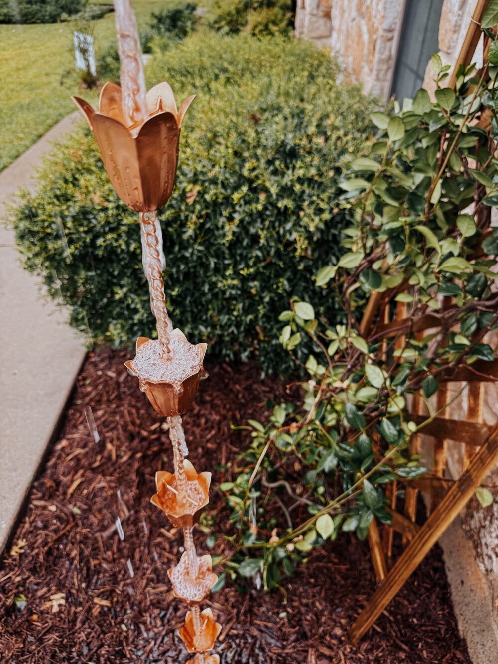 close up image of a brass rain chain