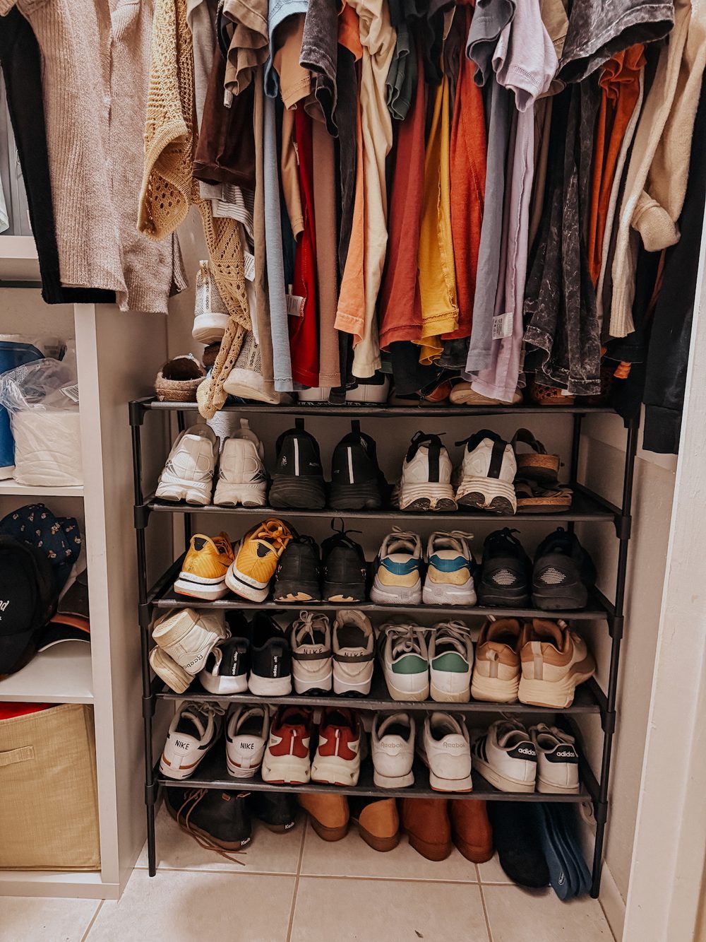 a shoe shelf in a small closet full of sneakers